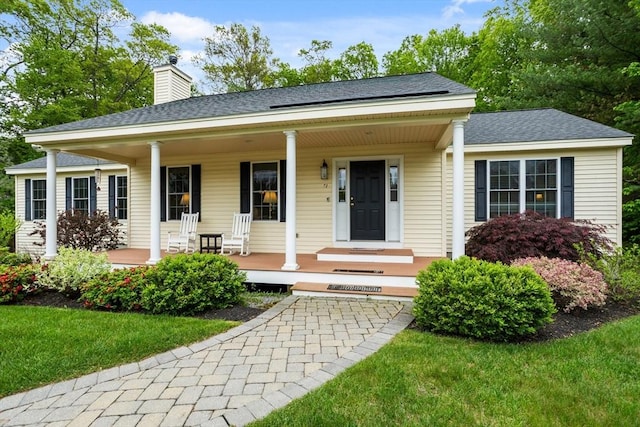 71 Fox Run Dr, Ayer, MA 01432 - view of front of house featuring a porch, a chimney, a shingled roof, and a front yard