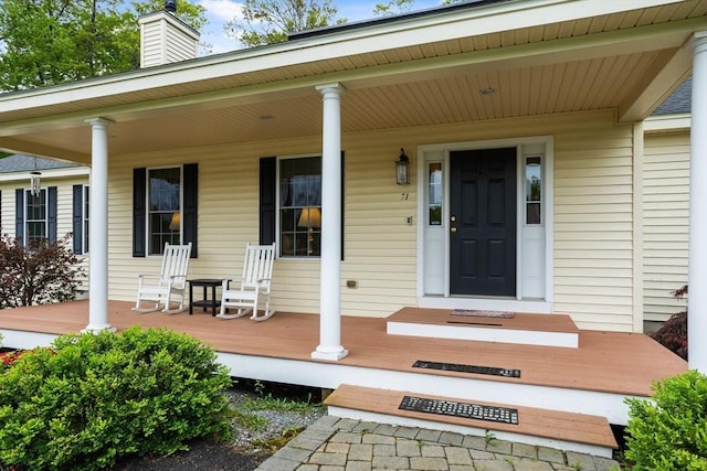 71 Fox Run Dr, Ayer, MA 01432 - view of exterior entry featuring a porch and a chimney