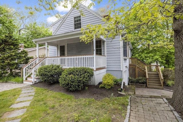 view of front of property with stairs and covered porch