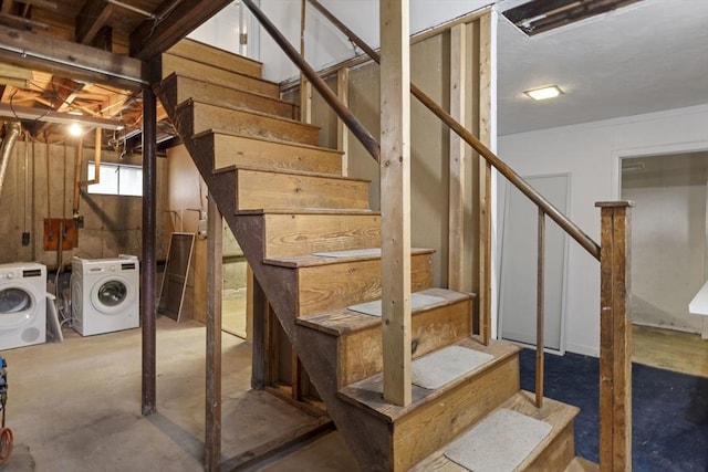 below grade area featuring washing machine and clothes dryer and stairs
