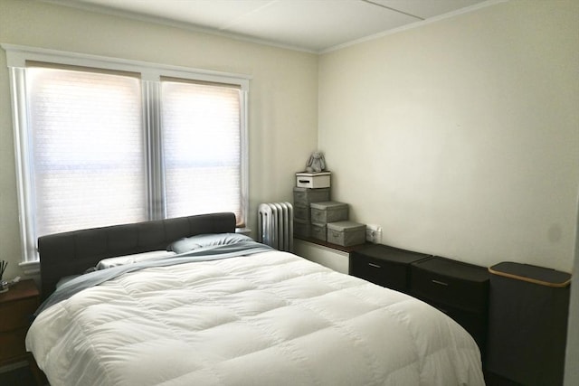 bedroom with radiator heating unit and ornamental molding
