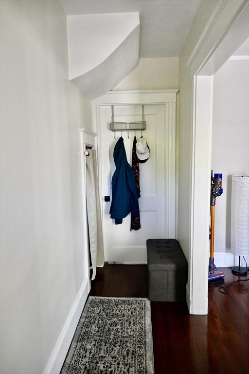 mudroom with wood finished floors and baseboards