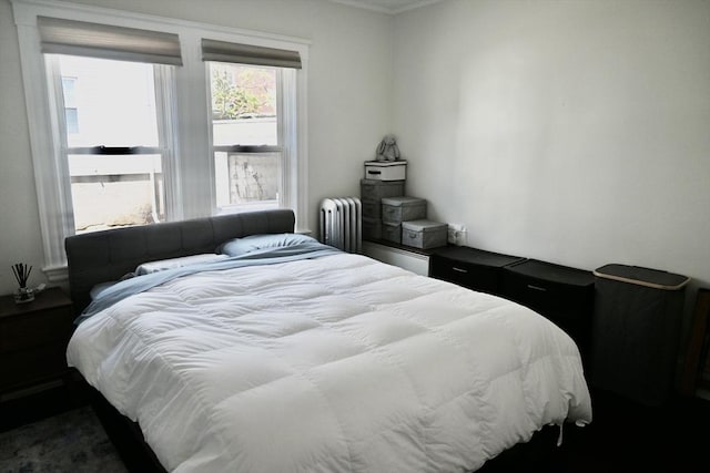bedroom featuring radiator heating unit and ornamental molding