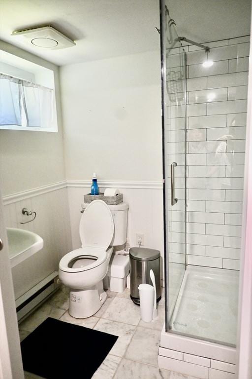 full bathroom featuring a baseboard radiator, toilet, and a stall shower