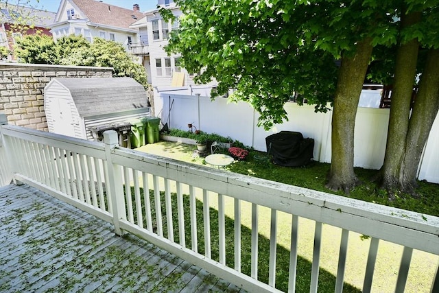 view of yard with fence and a storage shed