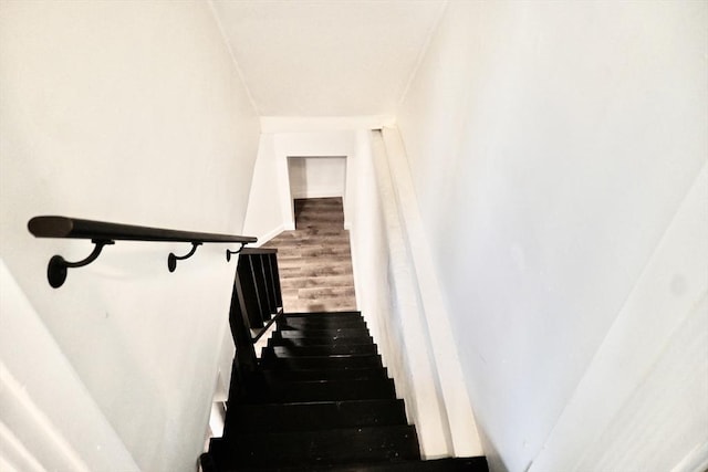stairway featuring wood finished floors and baseboards