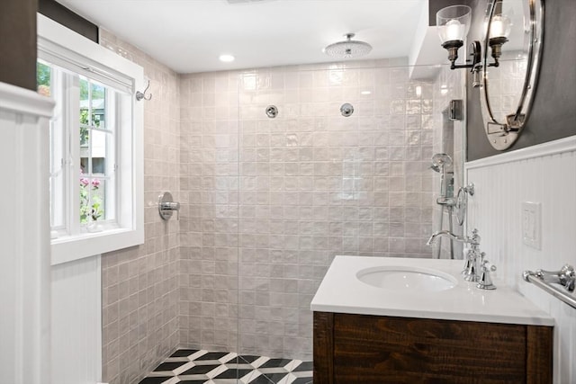 bathroom with vanity and tiled shower