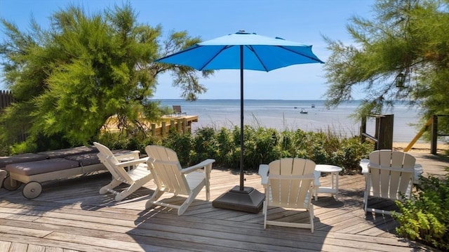 deck featuring a water view and a beach view