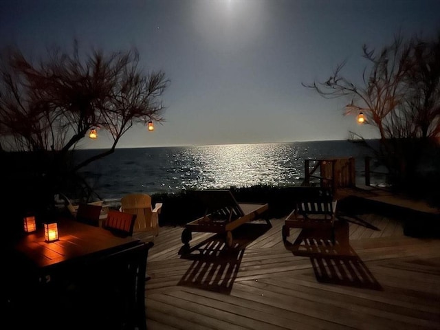 wooden terrace featuring a water view