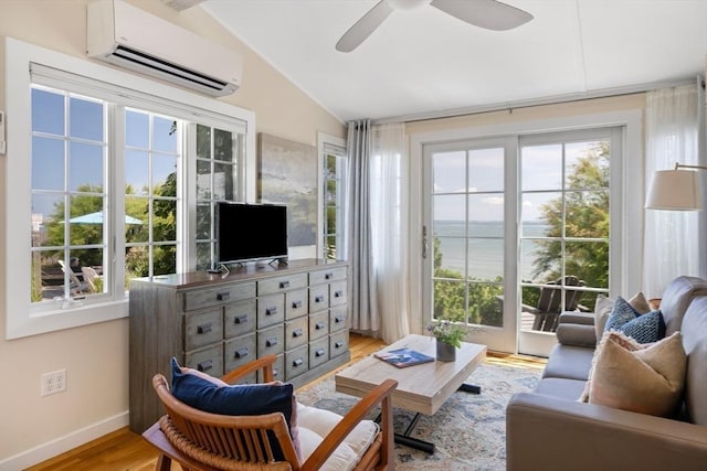 sunroom / solarium featuring a wall mounted air conditioner, vaulted ceiling, ceiling fan, and plenty of natural light