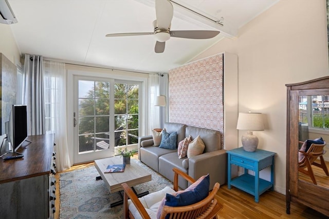 living room with hardwood / wood-style flooring, vaulted ceiling, a wall unit AC, and ceiling fan