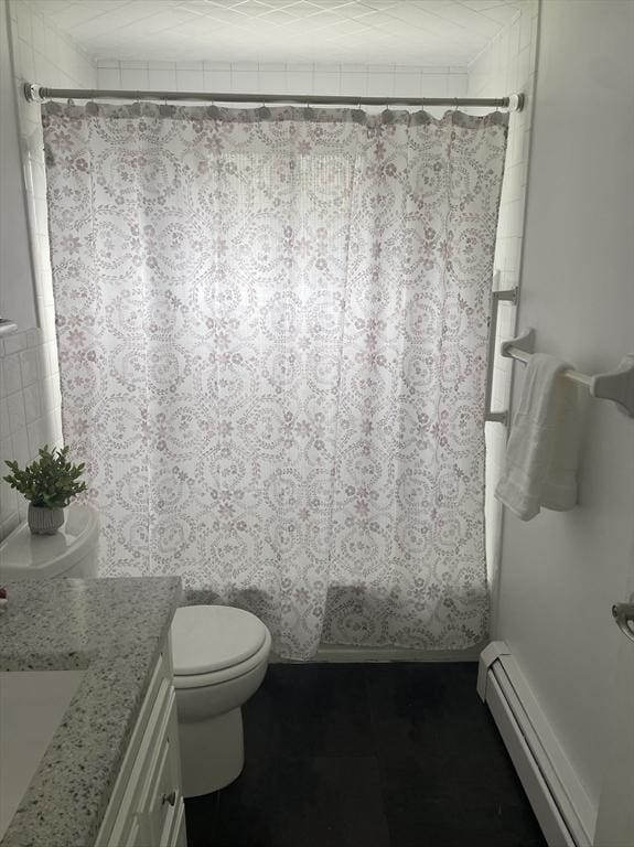 8 Zabriskie Unit 8B, Newburyport, MA 01950 - bathroom with a baseboard heating unit, vanity, toilet, and shower / tub combo with curtain