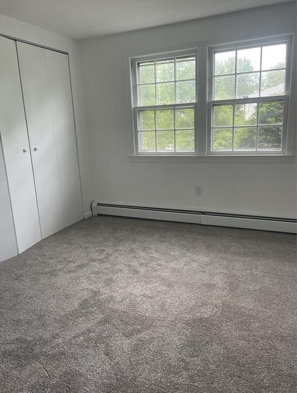 8 Zabriskie Unit 8B, Newburyport, MA 01950 - unfurnished bedroom with a baseboard radiator, a closet, and carpet flooring