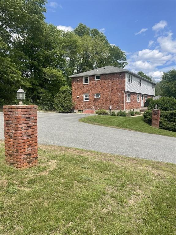 8 Zabriskie Unit 8B, Newburyport, MA 01950 - view of side of property with a yard, brick siding, and driveway