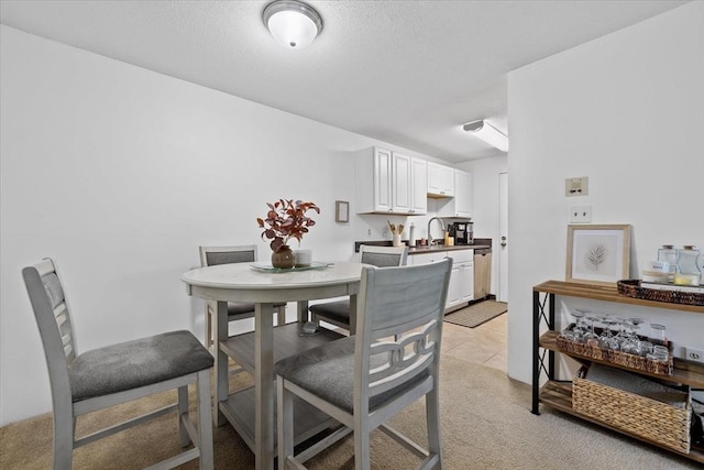 carpeted dining space featuring sink