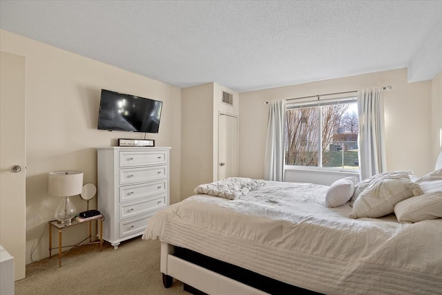 carpeted bedroom featuring a textured ceiling