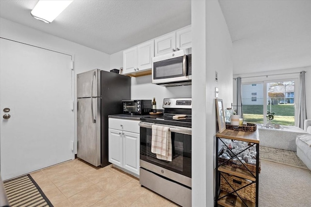 kitchen with wine cooler, white cabinetry, light tile patterned floors, and stainless steel appliances