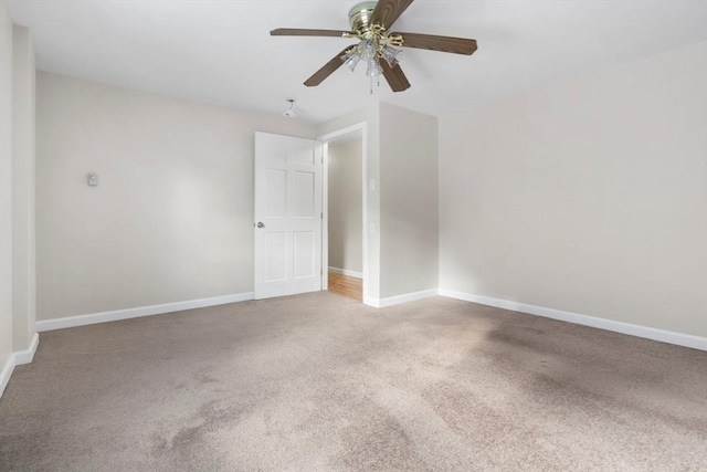 carpeted spare room featuring ceiling fan