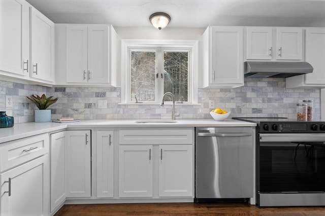 kitchen featuring white cabinets, backsplash, appliances with stainless steel finishes, and sink