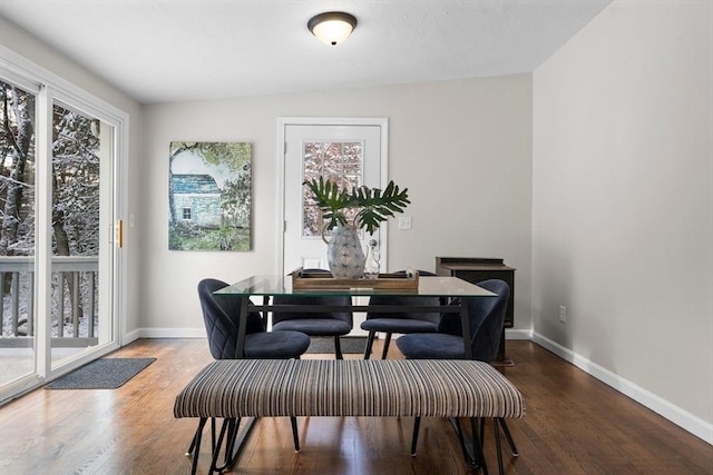 dining room with vaulted ceiling and hardwood / wood-style floors