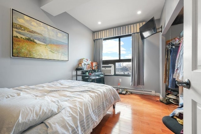 12 Stoneholm Unit 621, Boston, MA 02115 - bedroom featuring a baseboard radiator, wood finished floors, cooling unit, and recessed lighting