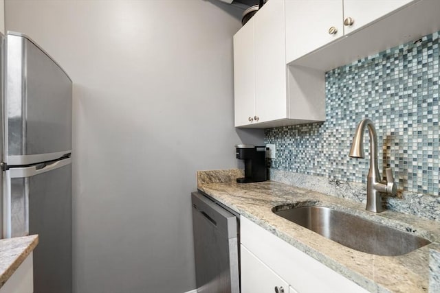 12 Stoneholm Unit 621, Boston, MA 02115 - kitchen with stainless steel appliances, backsplash, white cabinets, and light stone countertops