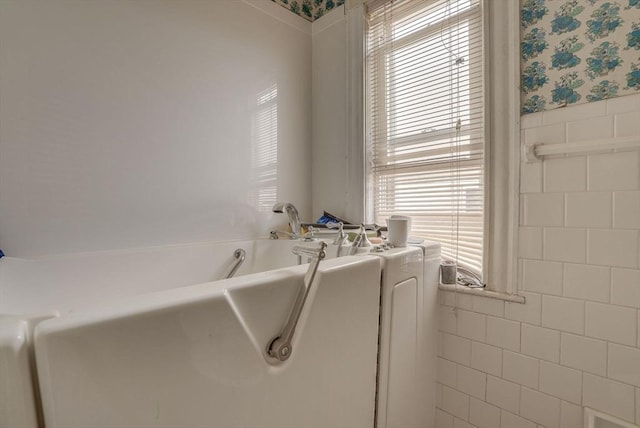 69 Metropolitan Ave, Boston, MA 02131 - bathroom with wallpapered walls, a bath, tile walls, and a wainscoted wall