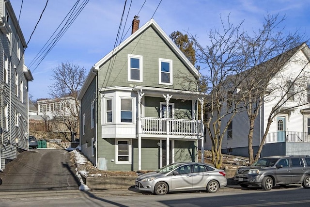 view of front of property featuring a balcony and a garage