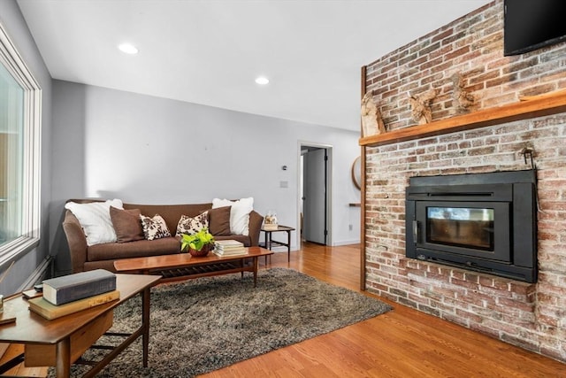 living room with hardwood / wood-style floors and a fireplace