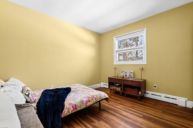 bedroom featuring dark hardwood / wood-style flooring and a baseboard heating unit