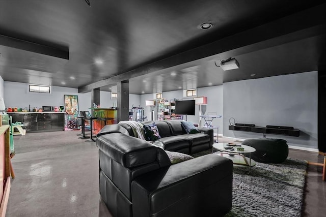 home theater room with bar area and concrete flooring