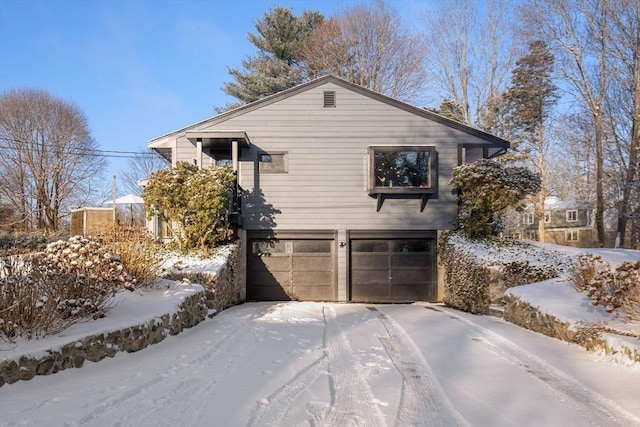 view of snow covered exterior featuring a garage