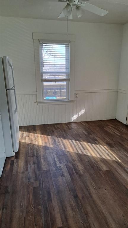 interior space featuring ceiling fan and dark hardwood / wood-style flooring