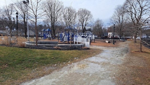 surrounding community featuring a playground and a lawn