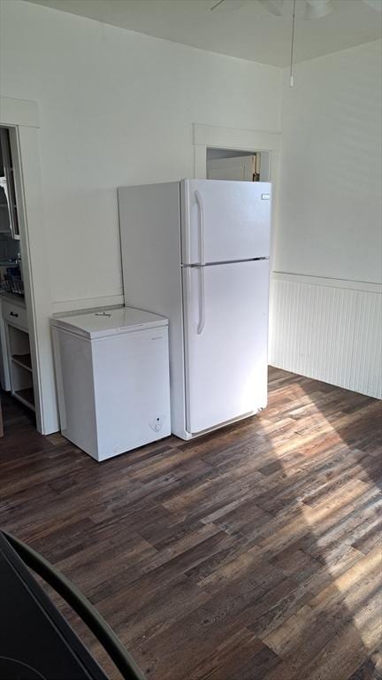 kitchen featuring fridge, dark hardwood / wood-style flooring, and white refrigerator