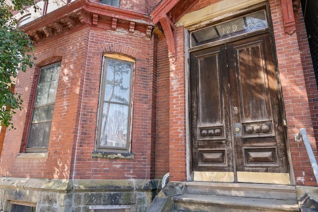 property entrance with brick siding and french doors