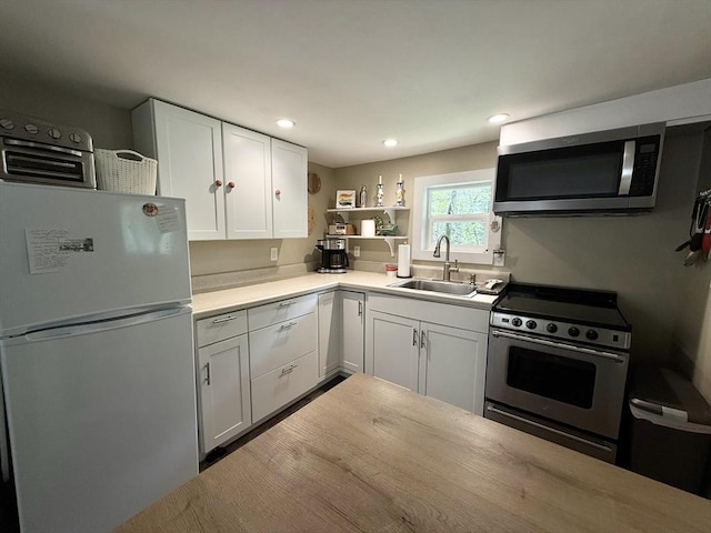 12 Cherry Rd, Goshen, MA 01032 - kitchen with stainless steel appliances, a sink, open shelves, white cabinetry, and light countertops