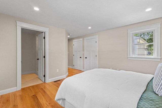 7 Grove St, Westford, MA 01886 - bedroom featuring light wood-style floors, recessed lighting, baseboards, connected bathroom, and multiple closets