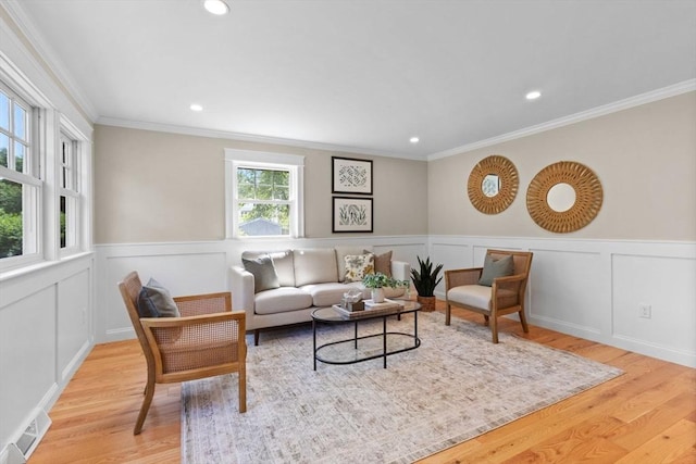 7 Grove St, Westford, MA 01886 - living room featuring light wood-style floors, recessed lighting, ornamental molding, and wainscoting