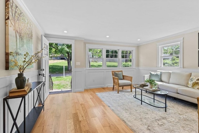 7 Grove St, Westford, MA 01886 - living room with crown molding, light wood-style floors, and a wainscoted wall