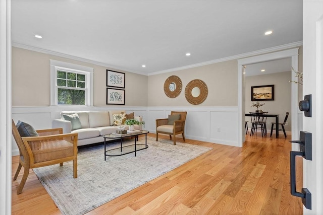 7 Grove St, Westford, MA 01886 - living room featuring wood finished floors, crown molding, recessed lighting, wainscoting, and a decorative wall