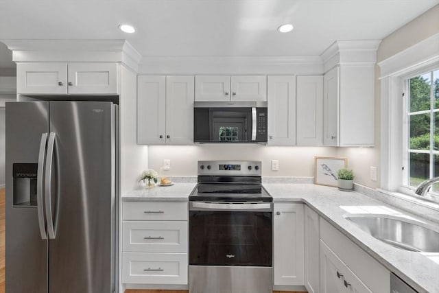7 Grove St, Westford, MA 01886 - kitchen with stainless steel appliances, a sink, white cabinets, light stone countertops, and recessed lighting