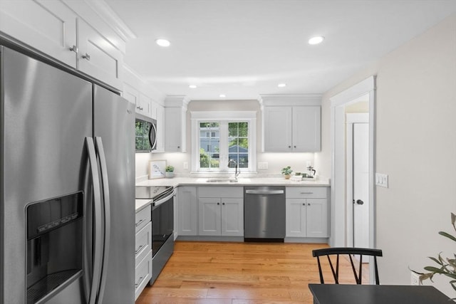7 Grove St, Westford, MA 01886 - kitchen with appliances with stainless steel finishes, a sink, white cabinets, light countertops, and recessed lighting