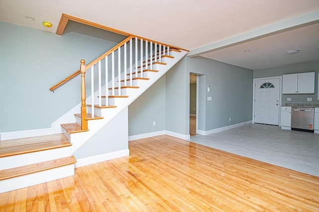 29 Roanoke St, Lynn, MA 01904 - unfurnished living room featuring stairway, wood finished floors, and baseboards
