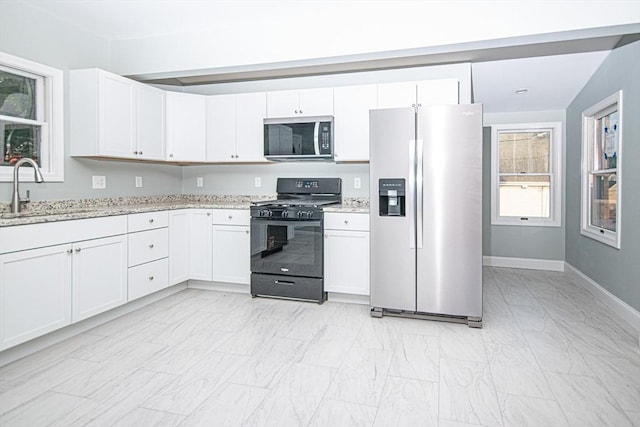29 Roanoke St, Lynn, MA 01904 - kitchen with stainless steel appliances, a sink, light stone countertops, and white cabinets