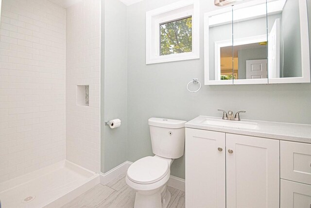 29 Roanoke St, Lynn, MA 01904 - bathroom with toilet, vanity, baseboards, and a tile shower