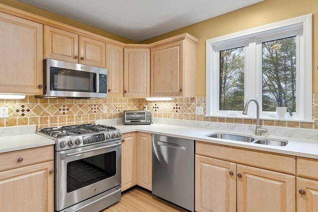 93 Towne Hill Rd, Haverhill, MA 01835 - kitchen with stainless steel appliances, light brown cabinets, a sink, and light countertops