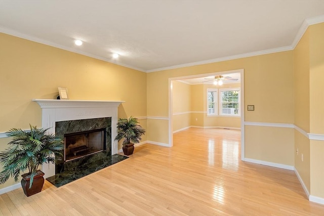 93 Towne Hill Rd, Haverhill, MA 01835 - living area with light wood-type flooring, a fireplace, baseboards, crown molding, and a ceiling fan