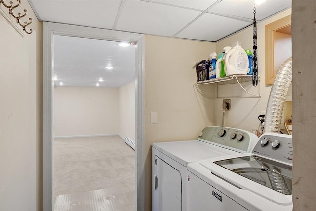 laundry area with baseboards, washing machine and clothes dryer, laundry area, light carpet, and a baseboard heating unit