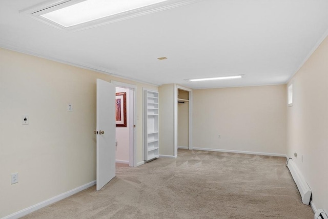 spare room with light carpet, baseboard heating, baseboards, and ornamental molding